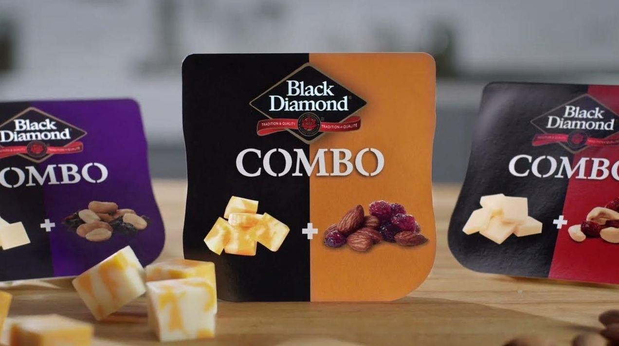 Black Diamond Combo packaging with cheese and nuts on a wooden surface