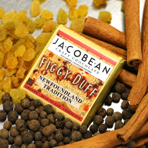 Jacobean Figgy Duff chocolate bar surrounded by raisins, cinnamon sticks, and allspice berries.
