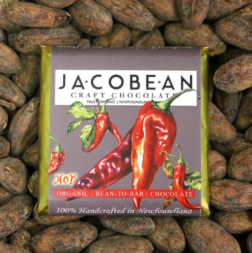 Jacobean craft chocolate bar with chili peppers on a bed of cocoa beans