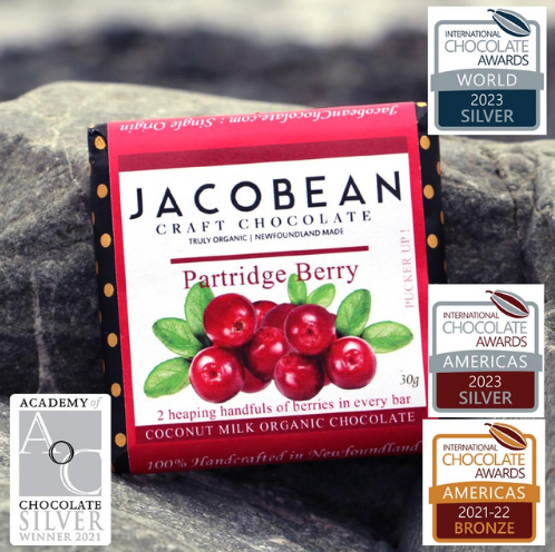 Jacobean Craft Chocolate Partridge Berry bar on a rock with award badges displayed.