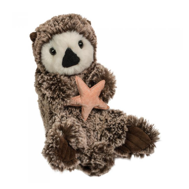 Plush toy otter holding a starfish on a white background